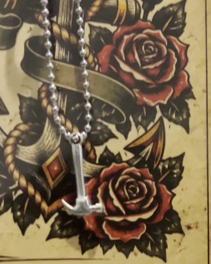 The small steel hammer hanging on its ball chain
